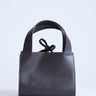 Topshop Sandy small real suede and leather grab bag with tie fastening in chocolate