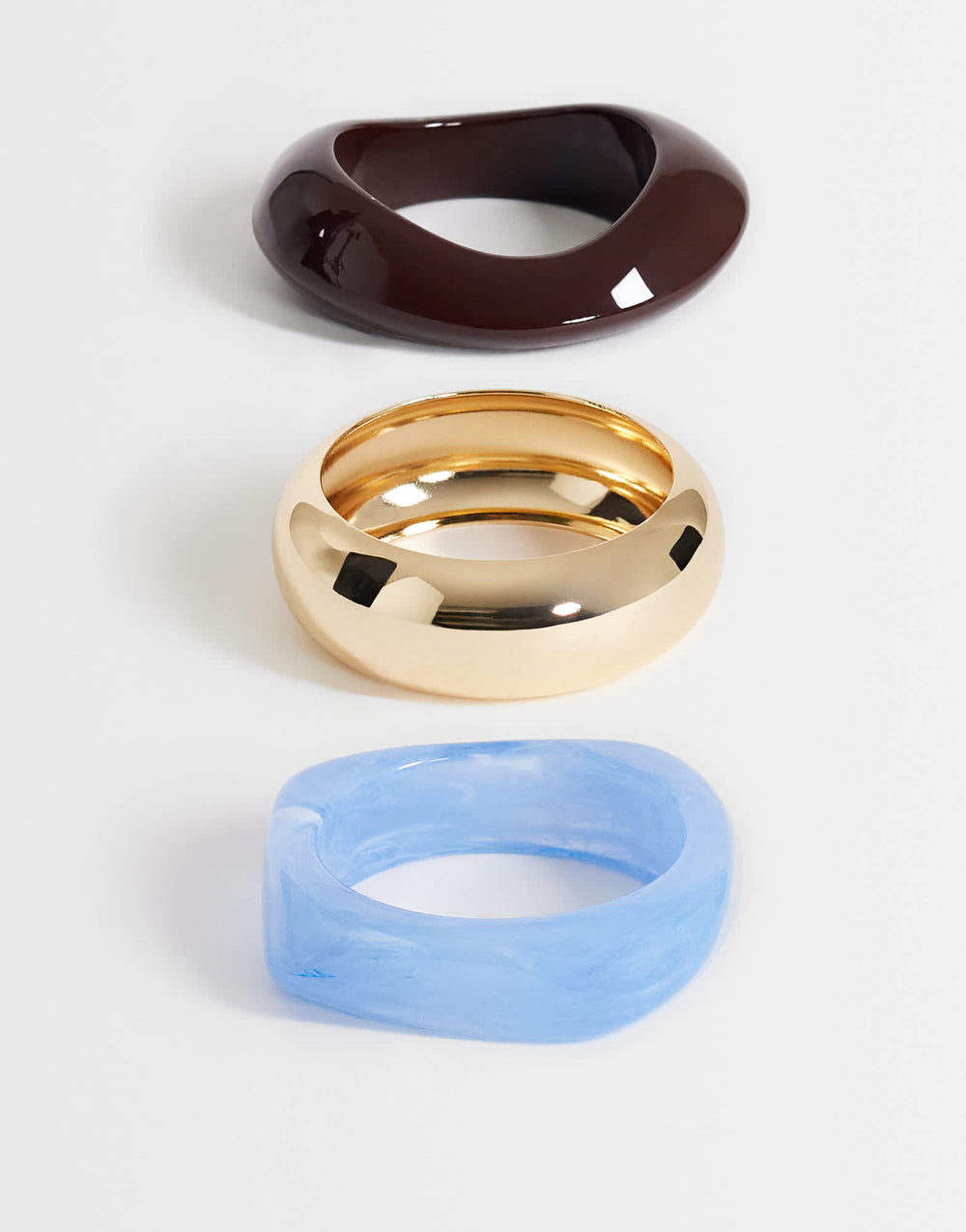 Topshop Finn 3 pack resin bangles in gold, blue and brown