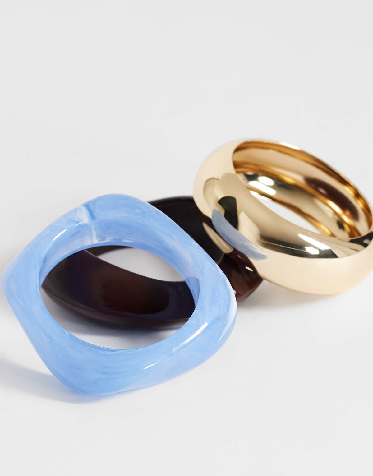 Topshop Finn 3 pack resin bangles in gold, blue and brown