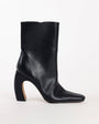 Topshop Karter curved heel ankle boot in black stretch faux leather