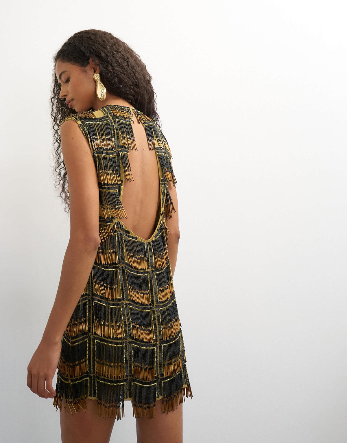 Topshop premium heavily embellished open back mini dress in black and gold